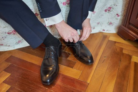 shiny black groom shoe with tuxedo trousers