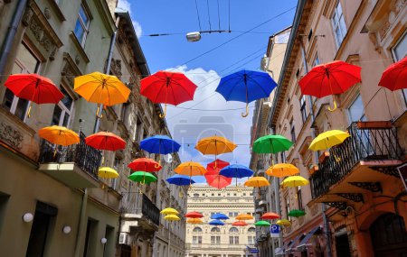 Romantically decorated with the umbrellas hanging from the wires on the narrow street of the old city