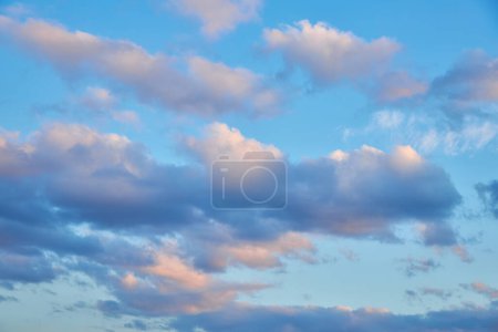 A captivating view of the sky at sunset, vibrant colors painting the clouds. Nature's dance unfolds, clouds gracefully move in the evening light