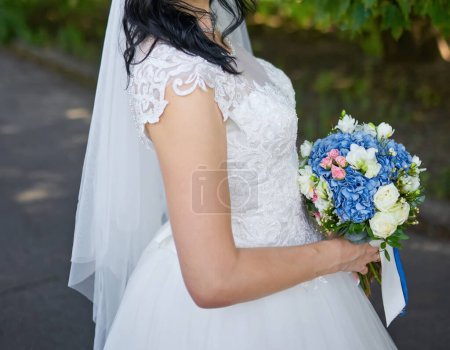 Photo for Tender hands cradle a bridal bouquet, a symbol of love and beauty. - Royalty Free Image