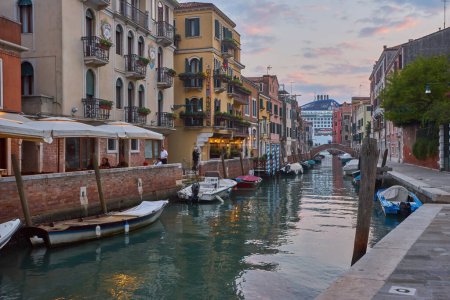 Photo for Venice, Italy - October 14, 2018: Beautiful narrow canal with silky water in Venice, Italy - Royalty Free Image