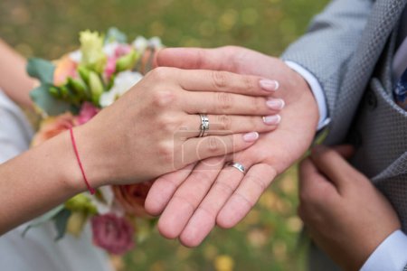 Photo for Bride and groom holding hands outdoors photo - Royalty Free Image