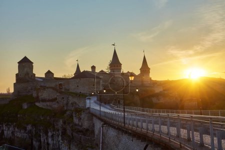 Old Castle medieval castle town of Kamenetz-Podolsk, Ukraine is one of the historical monuments. Trike powered paragliding trike on wheels circling in the air rolls of tourists