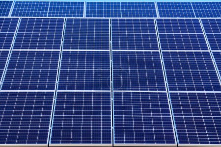 Photo for Solar panels on small wood board domestic house roof, sustainable energy concept. Lot of copy space on clear blue sky. - Royalty Free Image
