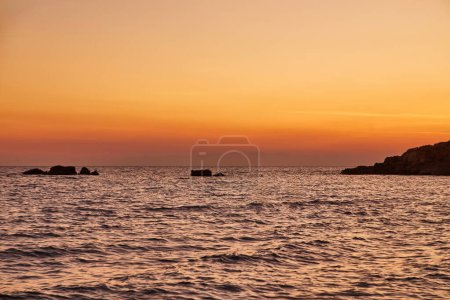Photo for Beautiful sunrise over water on the beach of Torre Dell'Orso. Salento coast, Apulia. Italy, Puglia. Bright sea sunrise. - Royalty Free Image