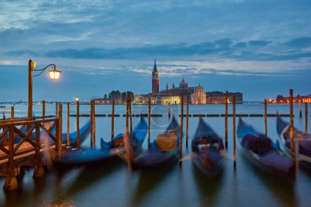 Gondolas at the St. Marks square in Venice, Italy, before a dramatic sunrise