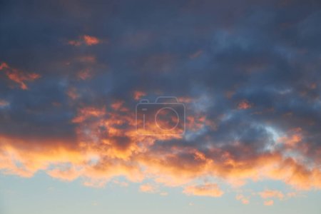 Photo for A captivating view of the sky at sunset, vibrant colors painting the clouds. Nature's dance unfolds, clouds gracefully move in the evening light - Royalty Free Image