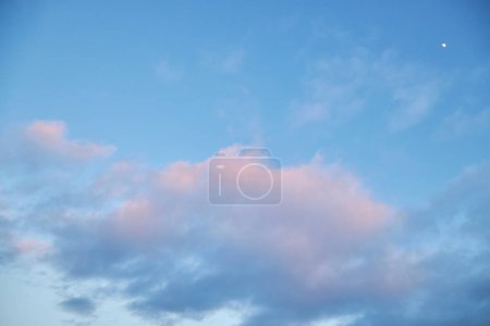A mesmerizing fragment of the sky, a natural backdrop featuring multicolored clouds with intriguing shapes illuminated by the setting sun, creating a breathtaking canvas of hues and patterns