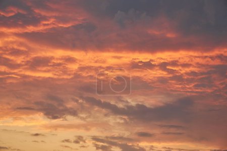 A captivating view of the sky at sunset, vibrant colors painting the clouds. Nature's dance unfolds, clouds gracefully move in the evening light