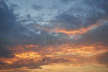 Photo for A mesmerizing fragment of the sky, a natural backdrop featuring multicolored clouds with intriguing shapes illuminated by the setting sun, creating a breathtaking canvas of hues and patterns - Royalty Free Image