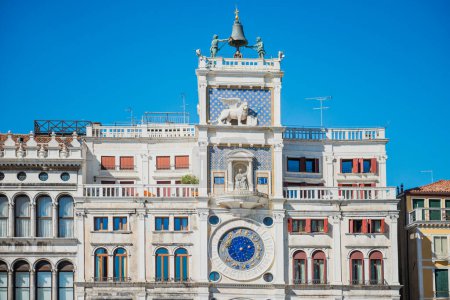 St Mark Clocktower with clock and statues. View from Piazza San Marco, Venice, Italy