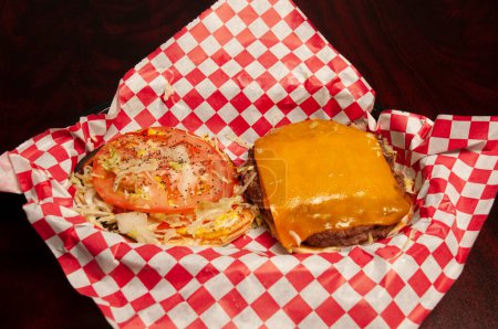 Téléchargez les photos : Délicieux cheeseburger avec toutes les fixations sur un chignon - en image libre de droit