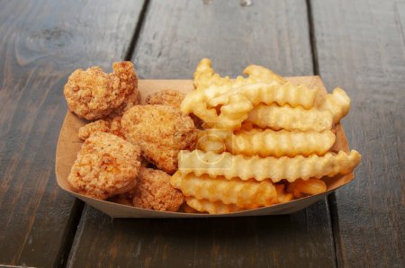 Photo for American cuisine dish known as chicken tenders and french fries - Royalty Free Image