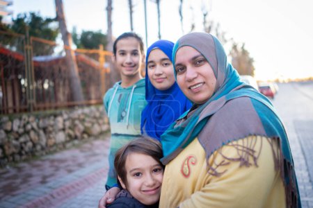 Photo for Real Muslim family on city street together - Royalty Free Image