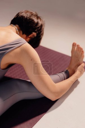Foto de Mujer joven deportiva haciendo práctica de yoga sobre fondo blanco. concepto de vida sana y equilibrio natural entre el cuerpo y el desarrollo mental. - Imagen libre de derechos