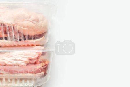 Photo for Fresh raw meat in package in plastic box, Close-up of meat in plate over light background. - Royalty Free Image