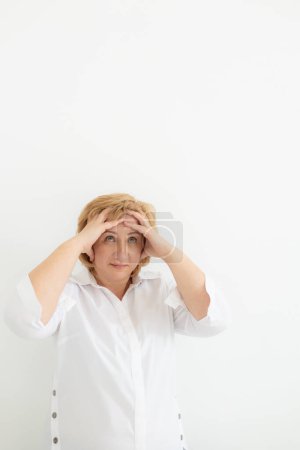 Close up of terrified mature woman look, scared senior female retiree feel scared frightened, face strong fear or anxiety at home, having panic attack. Senior woman looking at camera, copy space.
