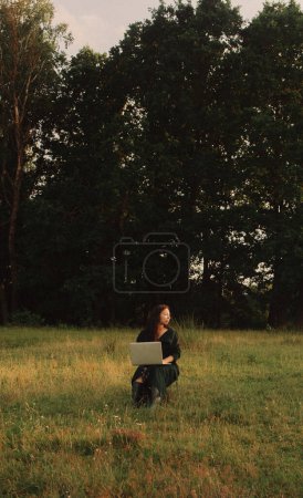 Photo for Woman using laptop in IT outside in eco-farm. Online chat. Spend free time on nature. Concept working from home, slow life, staying connected, social distancing, internet. Part of the series. - Royalty Free Image