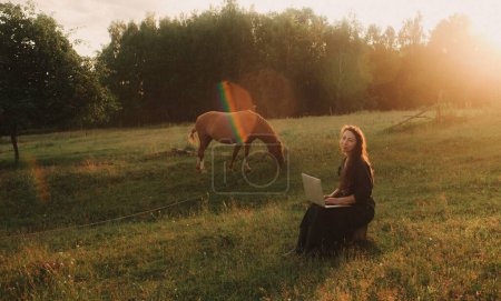 Photo for Woman using laptop in IT outside in eco-farm. Online chat. Spend free time on nature. Concept working from home, slow life, staying connected, social distancing, internet. Part of the series. - Royalty Free Image