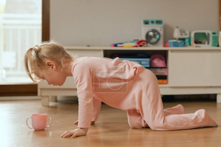Porträt eines glücklichen Babys, das im Spielzimmer mit Spielzeug spielt. Liebenswertes zweijähriges Mädchen im Spielzimmer. Generation-Alpha-Konzept.