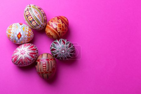 happy easter card. beautiful Easter egg Pysanka handmade on a pink backgroun