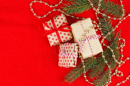 Foto de Rama de abeto de Navidad (abeto), cajas de regalo e.t.c sobre fondo rojo. - Imagen libre de derechos