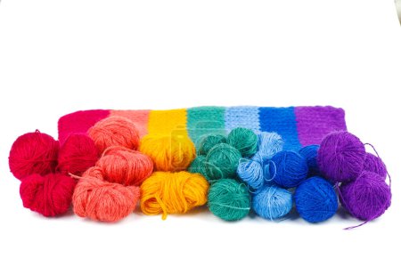 Photo for Rainbow knitted fabric and balls of wool thread isolated on white background - Royalty Free Image