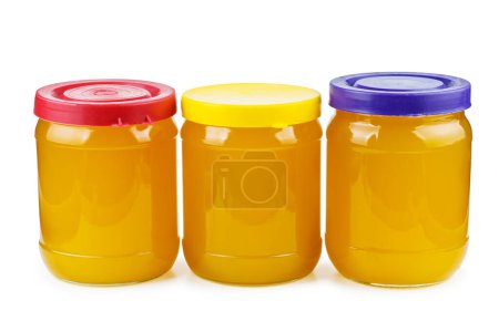 Foto de Glass jars with honey isolated on white background - Imagen libre de derechos