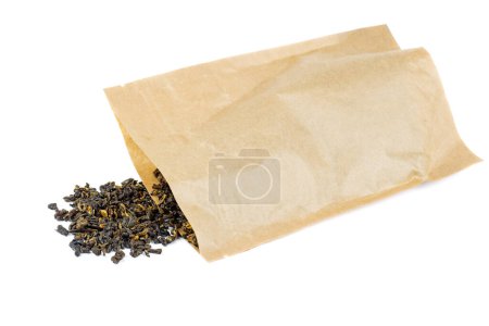Téléchargez les photos : Poche en papier brun et un peu de thé près sur un fond blanc - en image libre de droit