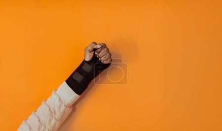 Photo for Isolated hurt hand of afro girl on yellow background. High quality photo - Royalty Free Image