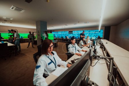 Photo for Group of female security operators working in a data system control room Technical Operators Working at the workstation with multiple displays, security guards working on multiple monitors in - Royalty Free Image
