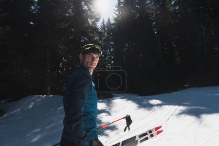 Photo for Portrait handsome male athlete with cross country skis in hands and goggles, training in snowy forest. Healthy winter lifestyle concept. High quality photo - Royalty Free Image