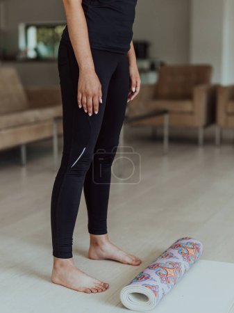 Photo for A woman in sports clothes resting after a hard online training session. - Royalty Free Image