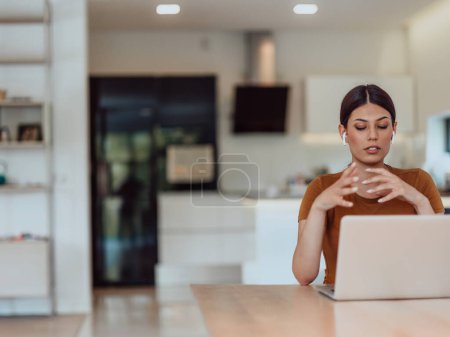 Photo for Woman sitting in living room using laptop looking at cam talk by video call with business friend relatives, head shot. Job interview answering questions - Royalty Free Image
