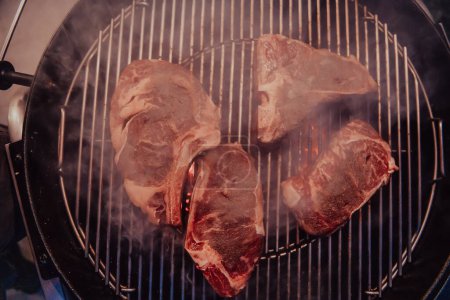 Photo for Close-up photo of delicious meat being grilled. In the background, friends and family are sitting and waiting for a meal. - Royalty Free Image