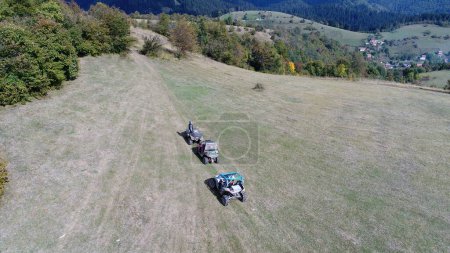 Photo for Aerial drone view of ATV quads on a dirt trail in forests. Off-road group team club enthusiasts having fun while driving countryside roads. High quality 4k footage - Royalty Free Image
