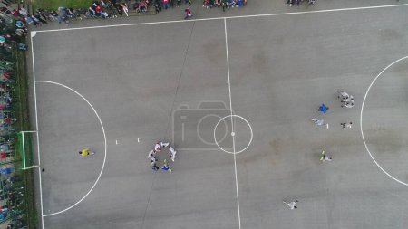 Photo for Top view drone flying above amateur soccer game match. Countryside authentic tournament. High quality 4k footage - Royalty Free Image