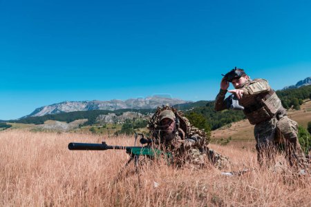 Téléchargez les photos : Sniper soldat assisté par un assistant pour observer la zone à cibler avec des lunettes de réalité virtuelle tactique moderne drone aérien technologie militaire - en image libre de droit