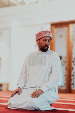 Photo for A Muslim praying in a modern mosque during the holy Muslim month of Ramadan. - Royalty Free Image