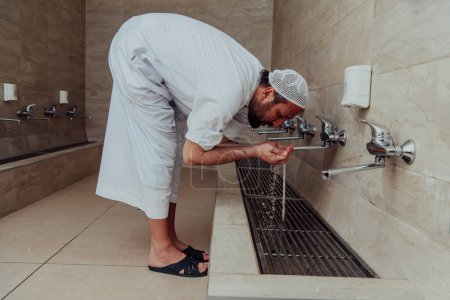Photo for A Muslim performing ablution. Ritual religious cleansing of Muslims before performing prayer. The process of cleansing the body before prayer. - Royalty Free Image
