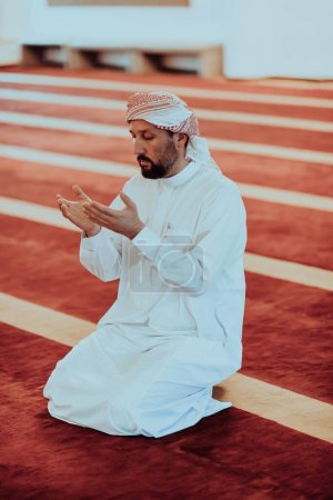 Photo for Muslim Arabic man praying. Religious muslim man praying inside the mosque during ramadan. High quality photo - Royalty Free Image