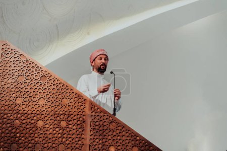 Photo for Muslims arabic Imam has a speech on friday afternoon prayer in mosque. Muslims have gathered for the friday afternoon prayer in mosque and are listening to the speech of imam. - Royalty Free Image