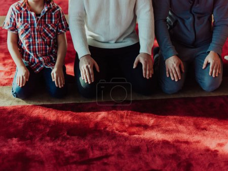 A group of Muslims in a modern mosque praying the Muslim prayer namaz, during the holy month of Ramadan. 