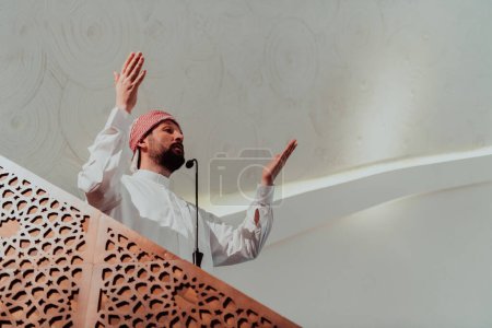 Photo for Muslims arabic Imam has a speech on friday afternoon prayer in mosque. Muslims have gathered for the friday afternoon prayer in mosque and are listening to the speech of imam. - Royalty Free Image
