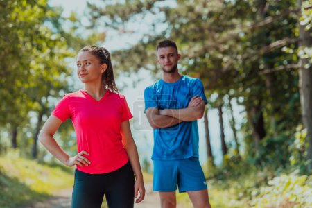 Photo for Couple enjoying in a healthy lifestyle while jogging on a country road. - Royalty Free Image