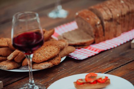 Foto de Composition with a glass of red wine and toasted bread. High quality photo - Imagen libre de derechos