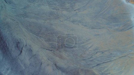 Foto de Top down aerial view over natural texture - abstract industrial lake water patterns. Turquoise waternature poluttion. Hi quality 4K footage. - Imagen libre de derechos