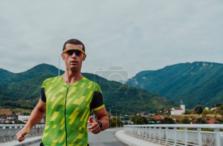 Photo for An athlete running a marathon and preparing for his competition. Photo of a marathon runner running in an urban environment. - Royalty Free Image