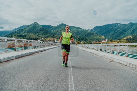 Photo for An athlete running a marathon and preparing for his competition. Photo of a marathon runner running in an urban environment. - Royalty Free Image