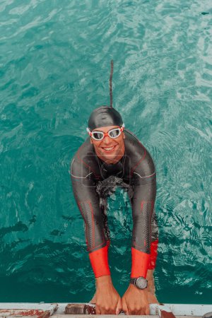 Photo for Triathlete swimmer portrait wearing wetsuit on training. - Royalty Free Image